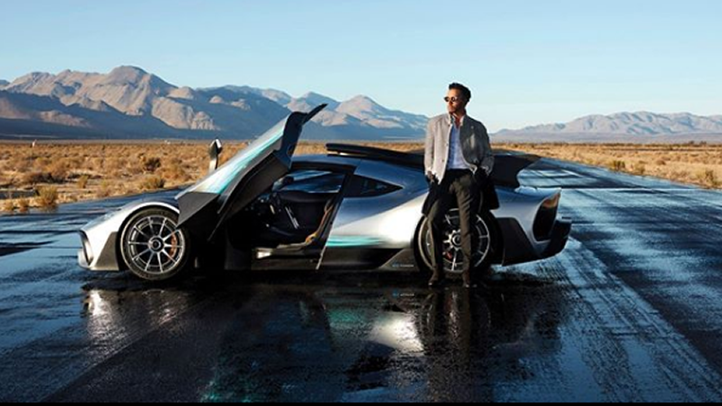 Man standing in front of sports car
