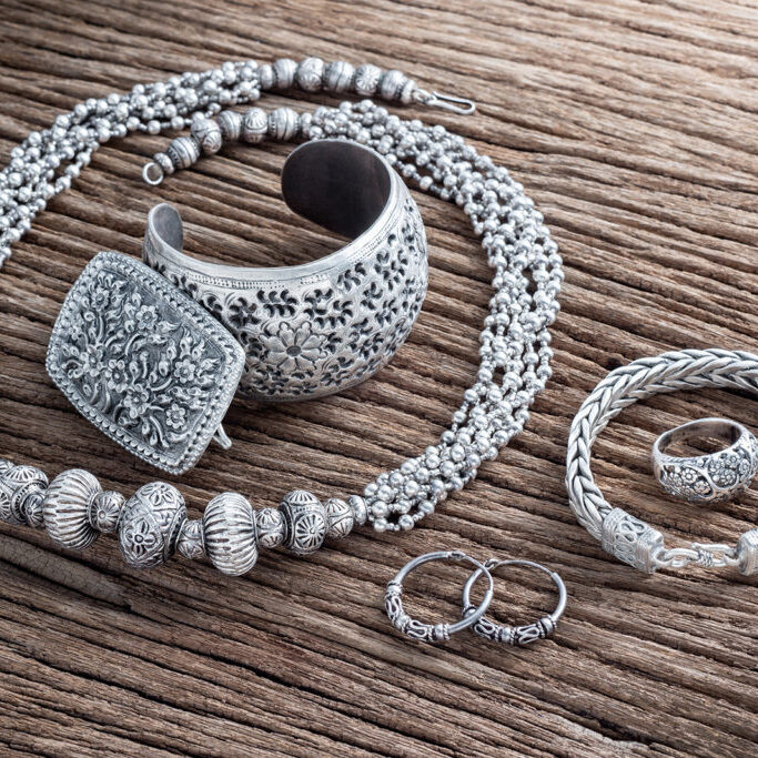 Collection of antique traditional silver jewellery on old wood